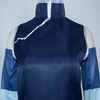 close up of Korra costume high neck top, silver diagonal trim, sleeveless design